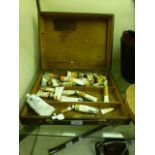 An artists box with an assortment of oils etc.