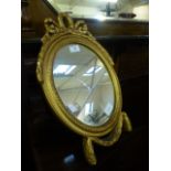 An ornate gilt framed oval easel mirror