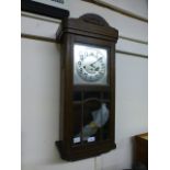 An early 20th century oak cased drop dial wall clock