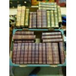 Two trays of leather bound books to include Websters Dictionary, Argosy etc.