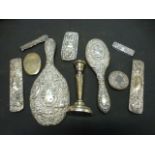 A selection of silver hallmarked items to include mirror, candlestick, bottle top etc.