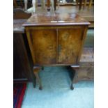 A reproduction burr walnut pot cupboard on cabriole legs