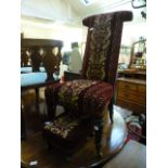 A 19th century rosewood prayer chair upholstered in a patterned cut red fabric along with a