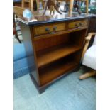 A reproduction mahogany bookcase having two drawers above open storage