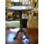 A mahogany wine table having a turned three column pedestal