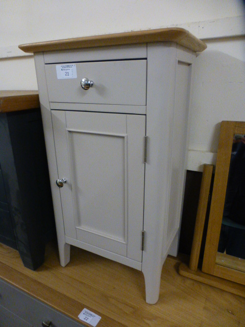 A cream painted pot style cupboard with single drawer and single cupboard (76.