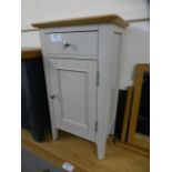 A cream painted pot style cupboard with single drawer and single cupboard (76.