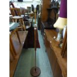 A mid 20th century teak and copper effect standard lamp