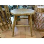 An oval topped wooden stool