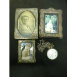 A silver plated pocket watch together with three silver fronted and white metal photo frames