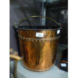 A copper peat bucket with brass handle