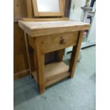 A reproduction pine butchers block with single drawer above open storage CONDITION