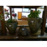 Two weathered stoneware planters in the form of urns together with a weathered stoneware model of a