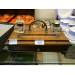 A Victorian oak desktop inkstand with three inkwells