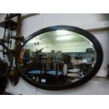 An early 20th century mahogany oval bevel glass mirror