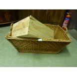 A wicker basket with handles along with a wine packing case