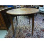 An early 20th century oak circular topped table on square tapering supports