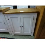 An ivory painted two door cupboard (82.