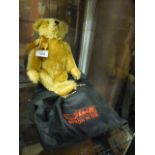 A light tan coloured Steiff Teddy bear with bag