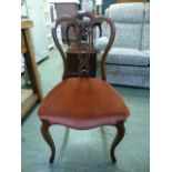 A Victorian rosewood bedroom chair having an overstuffed red dralon fabric seat