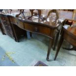 A reproduction mahogany serpentine fronted hall table having two drawers supported on square