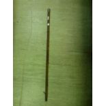 A bamboo walking cane with a silver hallmarked top