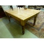 A early 20th century pine kitchen table,