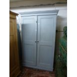 A pale blue painted two door cupboard