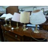 A collection of five brass table lamps