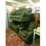 A green upholstered suite comprising of a three seater sofa,