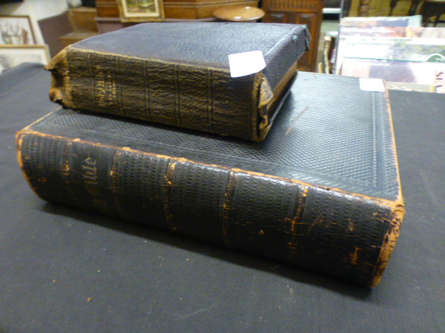 A leather bound family bible together with one other