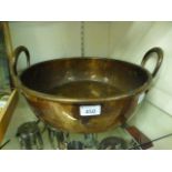 A copper twin handled pan