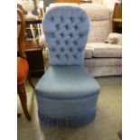 A turquoise upholstered button back bedroom chair