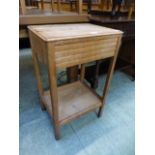 An oak veneered occasional table with single drawer over under tier