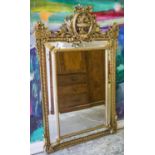 WALL MIRROR, Louis XVI style gilt composition with wreath and urn crest,