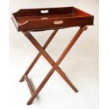 BUTLERS TRAY, 19th century mahogany galleried with pierced handles and folding stand,