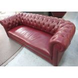 CHESTERFIELD SOFA, with a buttoned back, inner sides and burgundy leather upholstery,