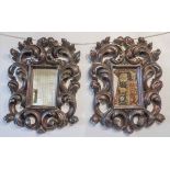 WALL MIRRORS, a pair, Italian design with scrolling composition frames in a dark painted finish,