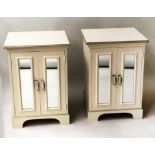 BEDSIDE CABINETS, a pair, cream and parcel gilt each with two mirror panelled doors,