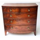 BOWFRONT CHEST, early 19th century flame mahogany, with two short and three long graduated drawers,