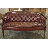 SOFA, 19th century style mahogany with serpentine seat and back in faded buttoned burgundy leather,
