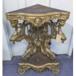 CORNER STAND, 19th century Italian giltwood with scrolled lattice and grotesque carvings,