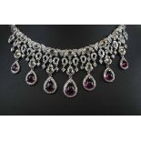 AN ATTRACTIVE RUBY, DIAMOND AND EIGHTEEN CARAT WHITE GOLD NECKLACE, of fringe design,