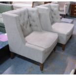 WING ARMCHAIRS, a pair, buttoned backs on wooden legs with brass castors.