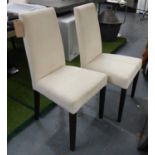DINING CHAIRS, a set of six, in cream, on ebonised legs.