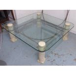 LOW TABLE, rounded edge glass top raised on spiral twist column's with metal work support,