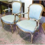 FAUTEUILS, a pair, 19th century French painted with distressed showframe and blue moire upholstery,