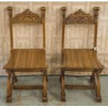 HALL CHAIRS, a pair, late 19th century Italian walnut with grotesque mask uprights and plank seats.