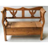 BOX SETTLE, 19th century Scandinavian pine with shaped back, scroll arms and lift up seat, 125cm W.
