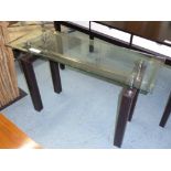 CONSOLE TABLE, with bevelled glass top, on square leather clad supports, 122cm x 44cm x 76cm H.